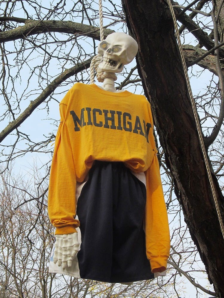 	<p>A skeleton wearing a Michigan shirt hangs from a tree in the 500 block of Spartan Avenue. Casey Holland/The State News</p>