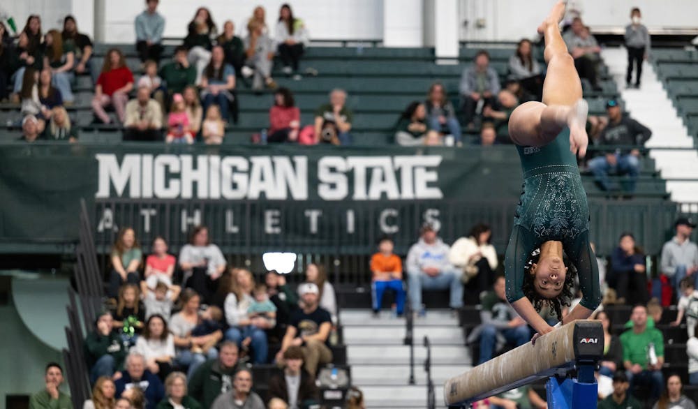 Gabi Ortiz, junior, performs a backhand spin on the balance beam during the MSU tri-meet at Jenison Field House on Sunday, Feb. 15, 2026.
