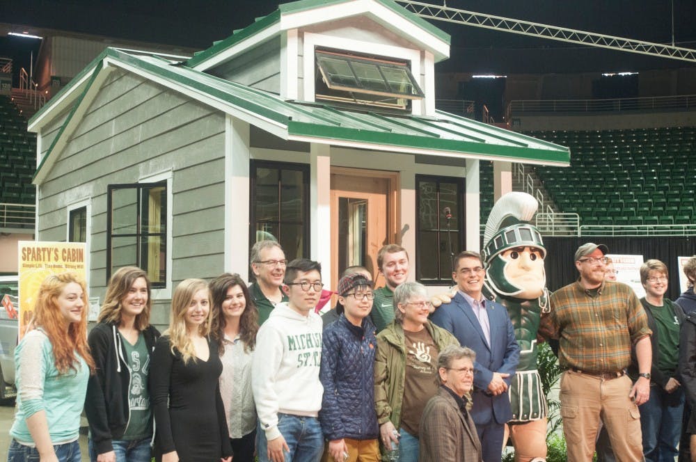 <p>The crowd at the opening of Sparty's Cabin pose for a photo on April 22, 2016 at Breslin Center.&nbsp;</p>
