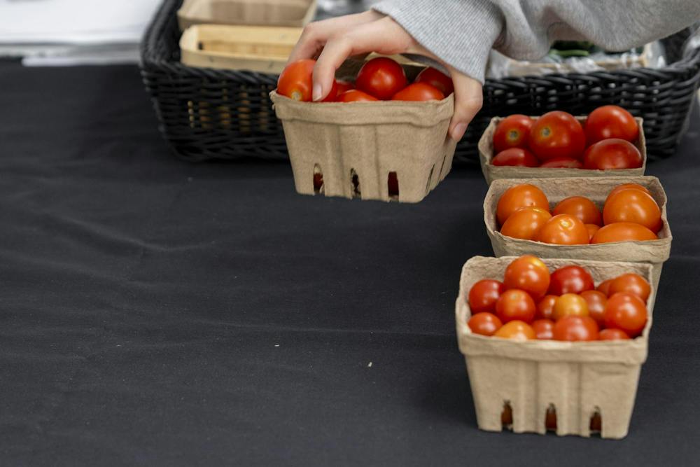 <p>Cherry tomato baskets are picked up by students to purchase during the MSU Culinary Services pop-up tent in East Lansing, Mich., on Wednesday, Sept. 16, 2026.</p>