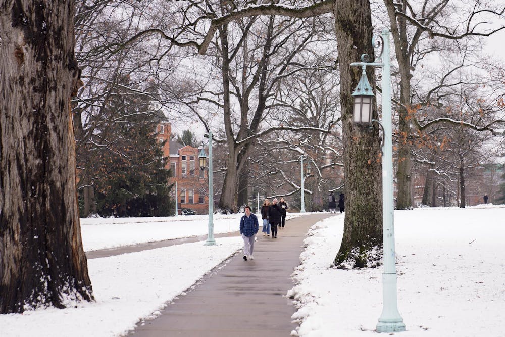 <p>Students make their way to and from campus the day before a heavy snow fall in East Lansing on Jan. 11, 2024.</p>