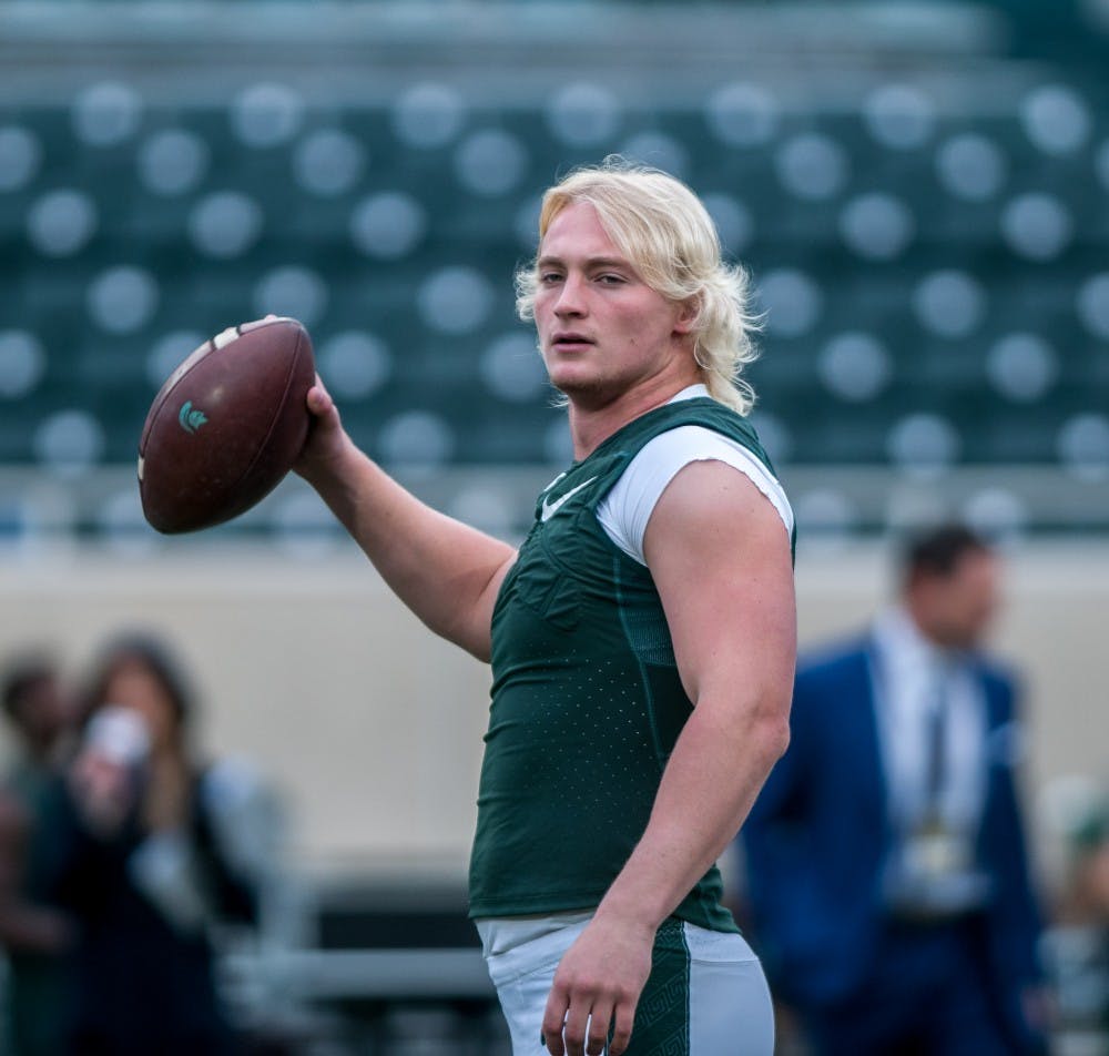 Redshirt freshman quarterback Rocky Lombardi warms up his arm prior to the game against Purdue on Oct. 27, 2018 at Spartan Stadium.