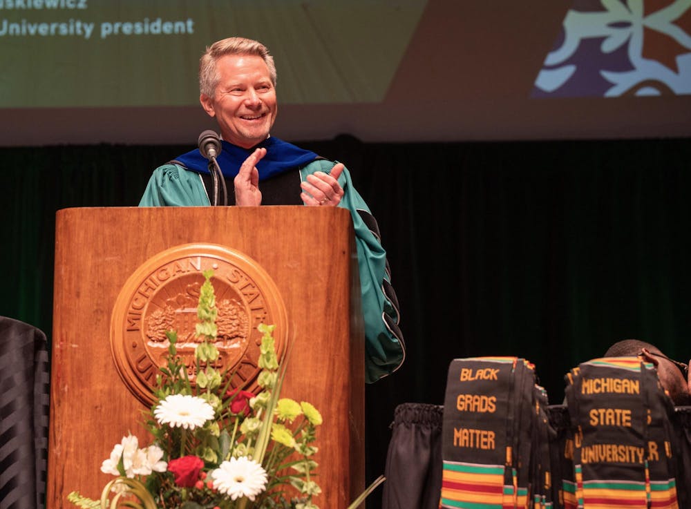 Michigan State University President Kevin Guskiewicz congratulates students during the annual Black Graduation ceremony at the Wharton Center on April 21, 2024.