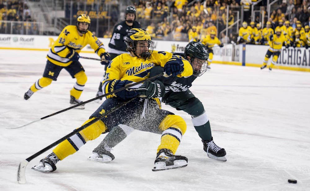 <p>Michigan State sophomore defense Owen West (11) fights to get the puck from University of Michigan freshman forward Cole McKinney (11) at the Yost Ice Arena in Ann Arbor, Mich. on Dec. 6, 2025. MSU defeated UM 3-1.</p>