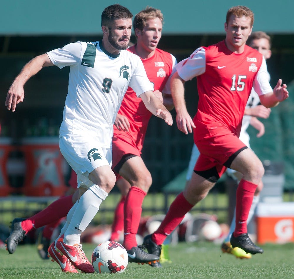 	<p>Sophomore midfielder Sean Conerty runs with the ball while Ohio State forward Denio Leone runs to block the pass on Oct. 13, 2013, during a game at DeMartin Stadium at Old College Field. The Spartans and the Buckeyes tied, 1-1. Georgina De Moya/The State News</p>