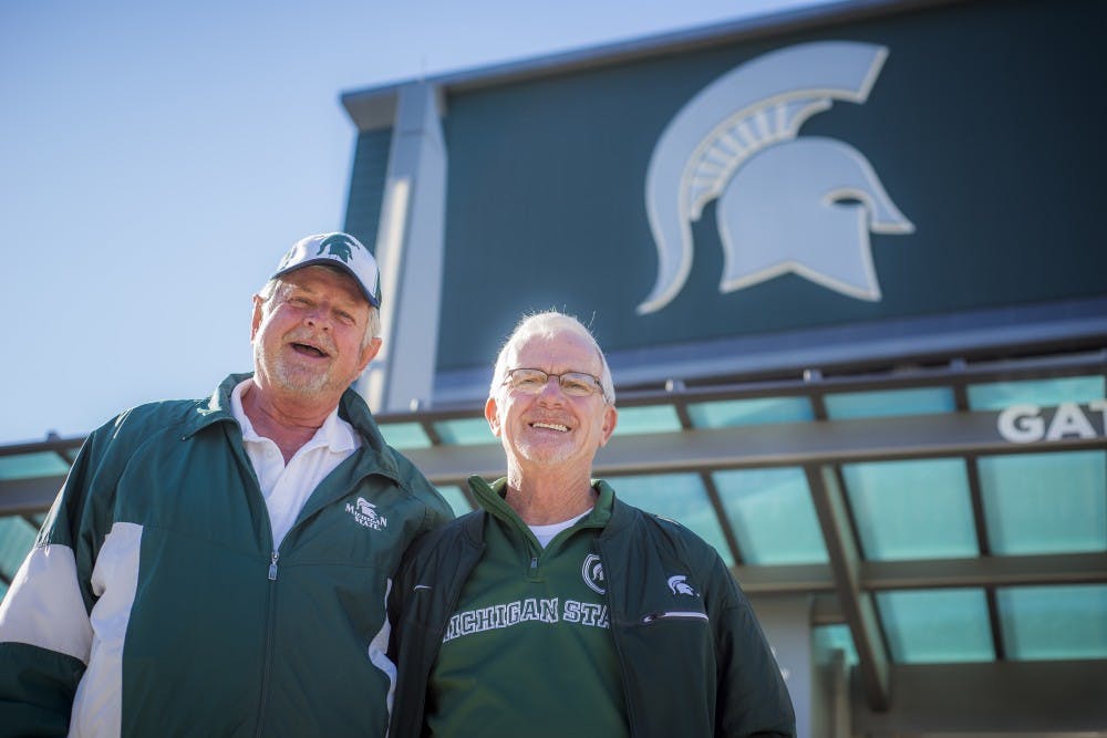 Charlie Thomas and Dave Rysztak pose for a picture on Oct. 17, 2017, outside of the North end zone at Spartan Stadium. 