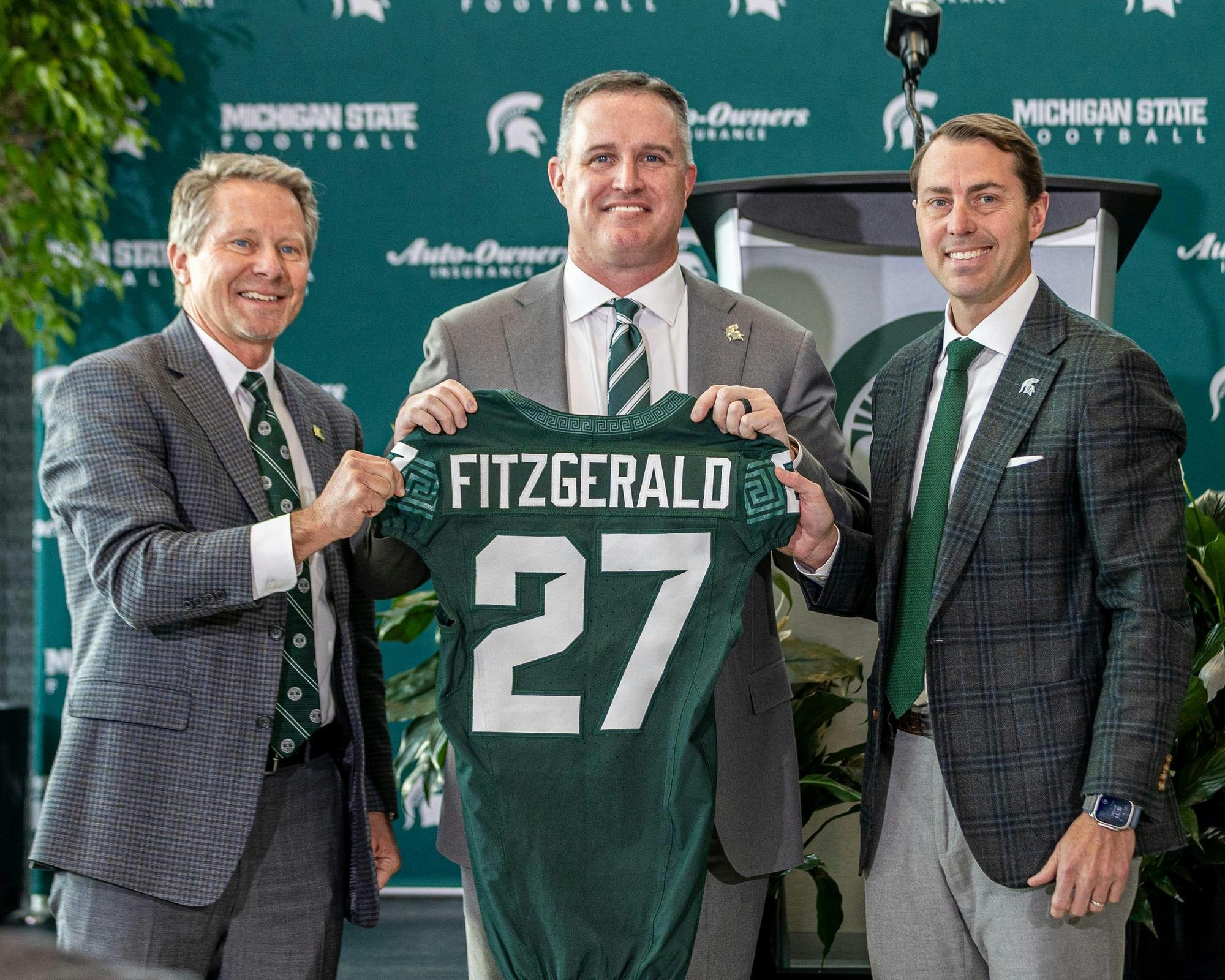 Michigan State University's new football HC Pat Fitzgerald poses with MSU's President, Kevin M. Guskiewicz and AD J Batts in the Tom Izzo football building in East Lansing, MI on Dec. 2, 2025.