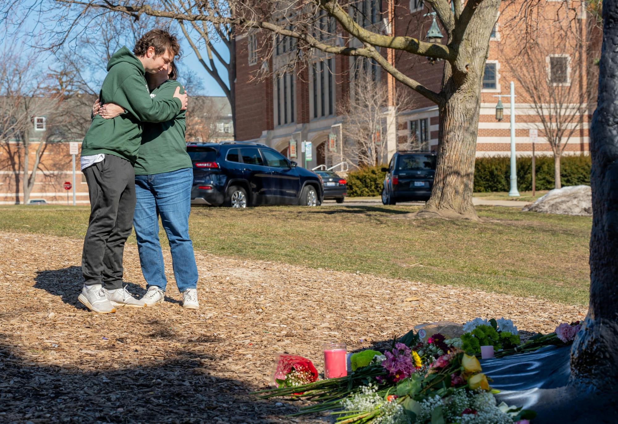 <p>Michigan State University business freshman Matthew Bowersock hugs his mother, Mary, as they pay their respects to the victims of the mass shooting at Michigan State University on Feb. 14, 2023, at The Rock on Farm Lane.</p>