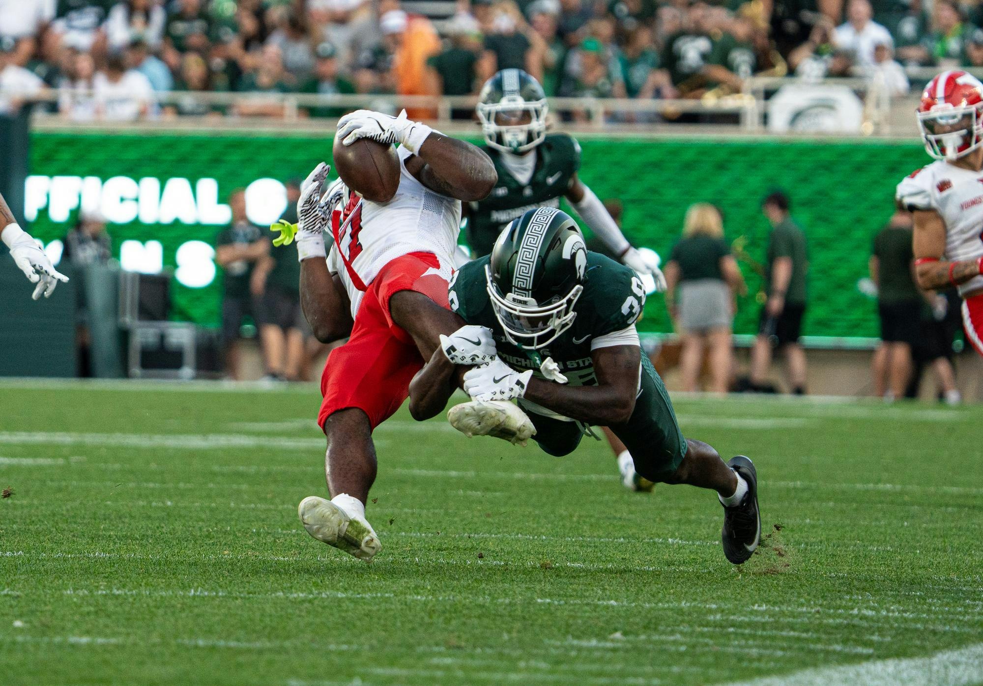 <p>MSU defiensive back Dorian Davis takes down Youngstown State running back Jaden Gilbert (7) during the match up against Youngstown state in Spartan Stadium in East Lansing, Michigan on Sept. 13, 2025.</p>