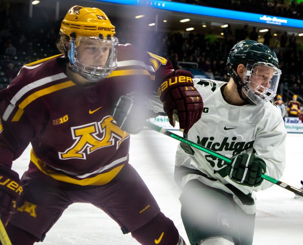 Sophomore wing Mitchell Lewandowski (9) fights for the puck along the boards during the game against Minnesota on Jan. 20, 2019. The Spartans are tied with the Golden Gophers 1-1 at the end of the first period.