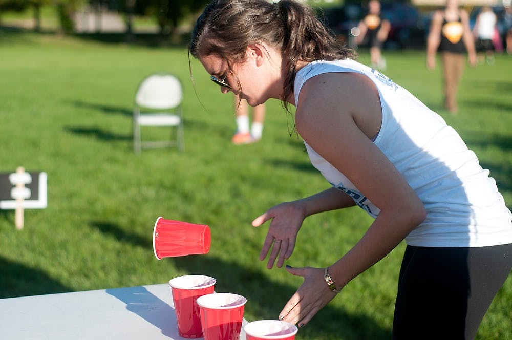 <p>Education sophomore Alyssa Goeckel participates in an obstacle during the Pi Kappa Alpha Fireman Challenge on Oct. 1, 2014, at Valley Court Park. This is a three day charity event to raise money for blood cancer research. Jessalyn Tamez/The State News</p>