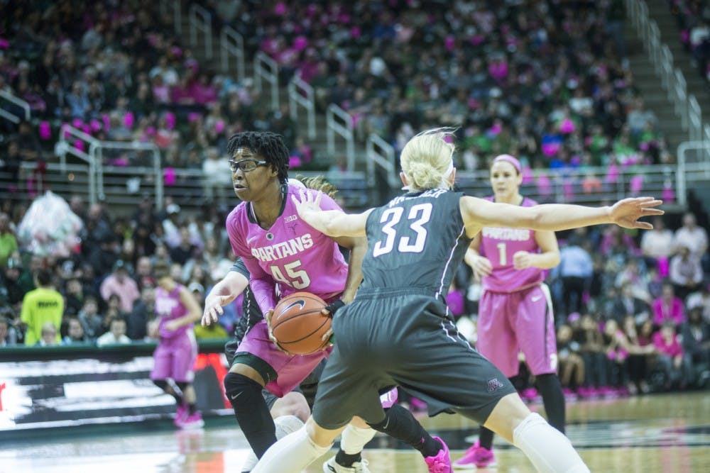 Graduate student forward Akyah Taylor goes to shoot a basket while Minnesota guard Carlie Wagner attempts to defend her during the game against Minnesota on Feb. 21, 2016 at Breslin Center. The Spartans defeated the Golden Gophers 114-106.