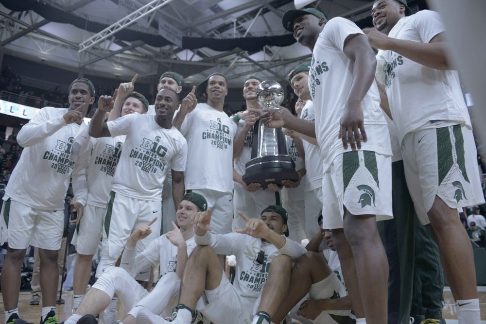 The Spartans pose with the Big Ten Championship trophy after the game against Illinois on Feb. 20, 2018 at Breslin Center. The Spartans defeated Illinois 81-61 and were crowned the 2018 Big Ten Champions. (Annie Barker | The State News)