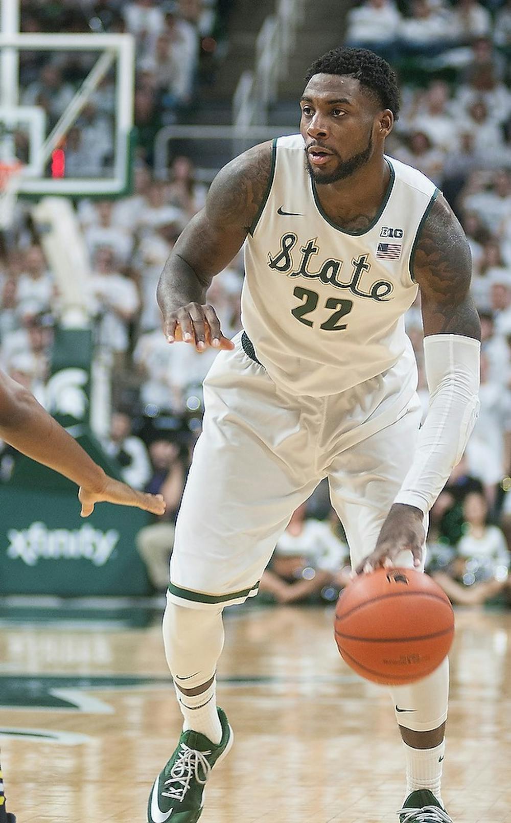 <p>Senior forward Branden Dawson dribbles the ball Feb. 2, 2015, during the game against Michigan at Breslin Center. The Spartans defeated the Wolverines in overtime, 76-66. Alice Kole/The State News</p>