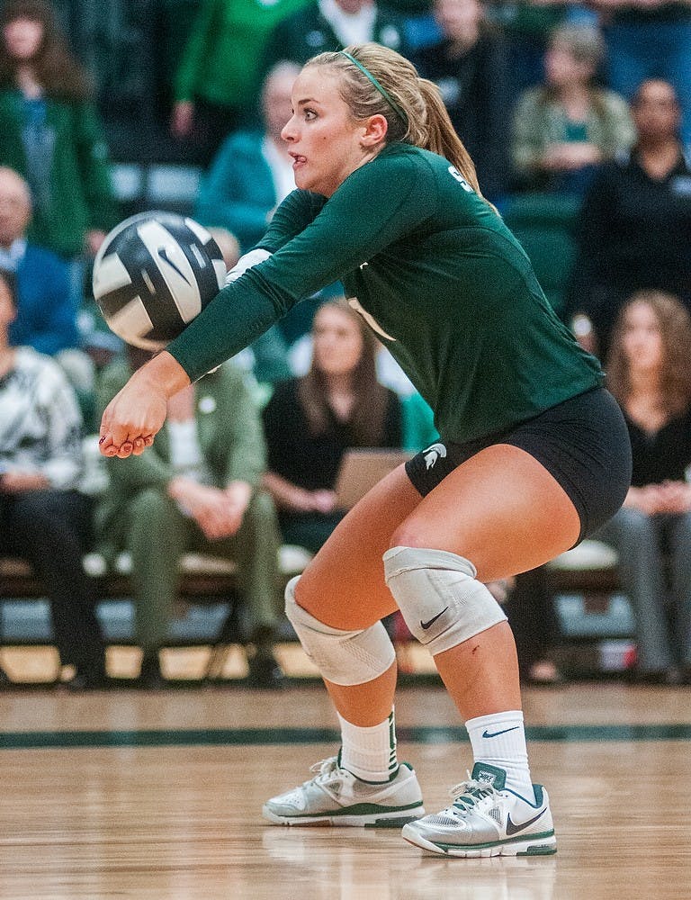 	<p>Sophomore libero Kori Moster bumps the ball to a teammate Wednesday, Nov. 21, 2012, at Jenison Field House. The Wolverines defeated the Spartans in three straight sets during senior night for the Spartans. Adam Toolin/The State News</p>