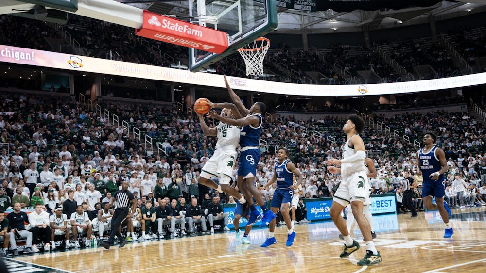 <p><br></p><p>MSU Sophomore Guard Tre Holloway (5) jumps for the basket against stiff Georgia Southern opposition during their game at the Jack Breslin Student Events Center on Nov. 28, 2023. Holloway's Spartans would go on to defeat the Georgia Southern Eagles 86-55.</p>