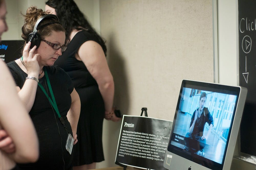 <p>MSU Recruitment coordinator Lizzy King watches a video made by RCAH freshman Amy Wagenaar on April 21, 2014, at Snyder and Phillips Halls. The project was about Macklemore and how he began bringing acceptance of homosexuality into the music industry. Betsy Agosta/The State News</p>