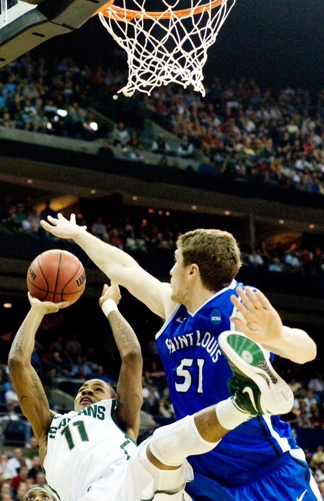 Sophomore guard Keith Appling attempts to shoot over St. Louis freshman Rob Loe Sunday afternoon at Nationwide Arena, Columbus, Ohio. Appling was 50 percent for field goals in the 65-61 Spartan victory over the St. Louis Billikens. Jaclyn McNeal/The State News. 