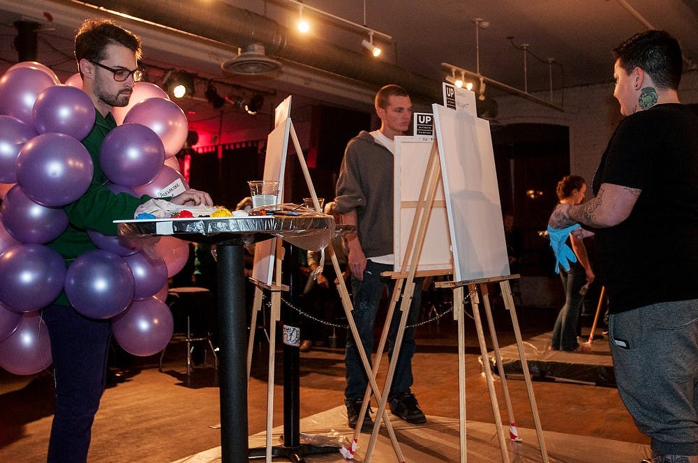 <p>From left, Farmington, Mich., resident Alexander Cyr, Lansing resident Brad Pollack and Lansing resident Brandi Wolgast prepare their pallets and easels for the first round of the Ultimate Painting live art competition on Nov. 1, 2014, at The Loft. Pollack tied for 2nd place in the competition. Raymond Williams/The State News</p>