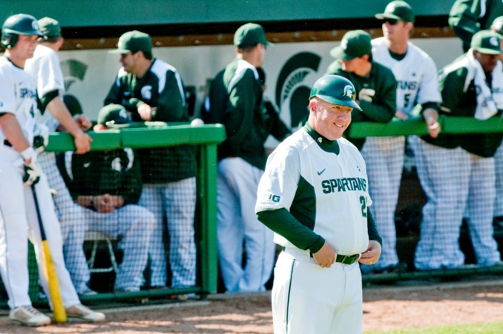 Head coach Jake Boss Jr. smiles after junior infielder Ryan Jones finished a run. The Spartans defeated the Broncos, 13-3, Tuesday afternoon at McLane Baseball Stadium at Old College Field. Justin Wan/The State News