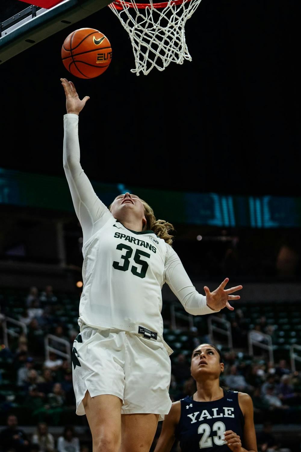 Michigan State redshirt freshman guard Kennedy Blair (35) goes for a basket while Yale junior guard Lola Lesmond (23) watches anxiously at the Breslin Center on Nov. 8, 2024. The Spartans took a 100-44 victory over the Bulldogs.