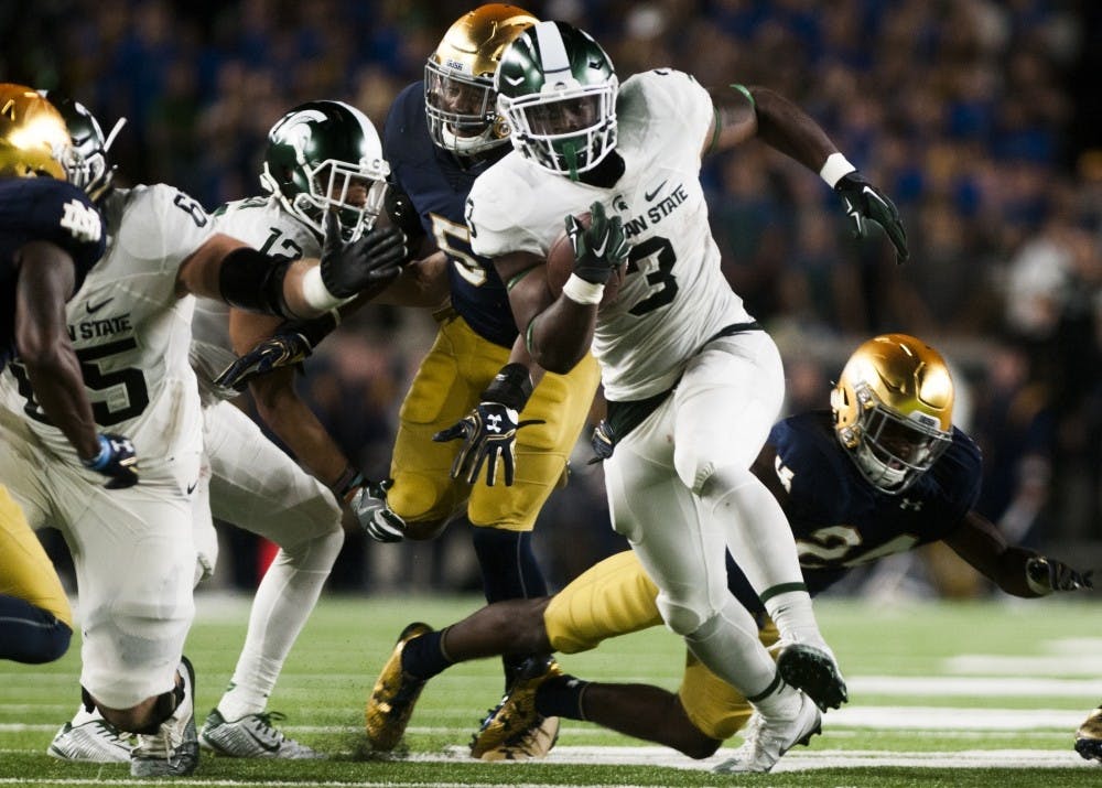 Sophomore running back LJ Scott (3) breaks the tackle of Notre Dame defensive back Nick Coleman (24) during the game against Notre Dame on Sept. 17, 2016 at Notre Dame Stadium in South Bend, Ind. The Spartans defeated the Fighting Irish, 36-28.