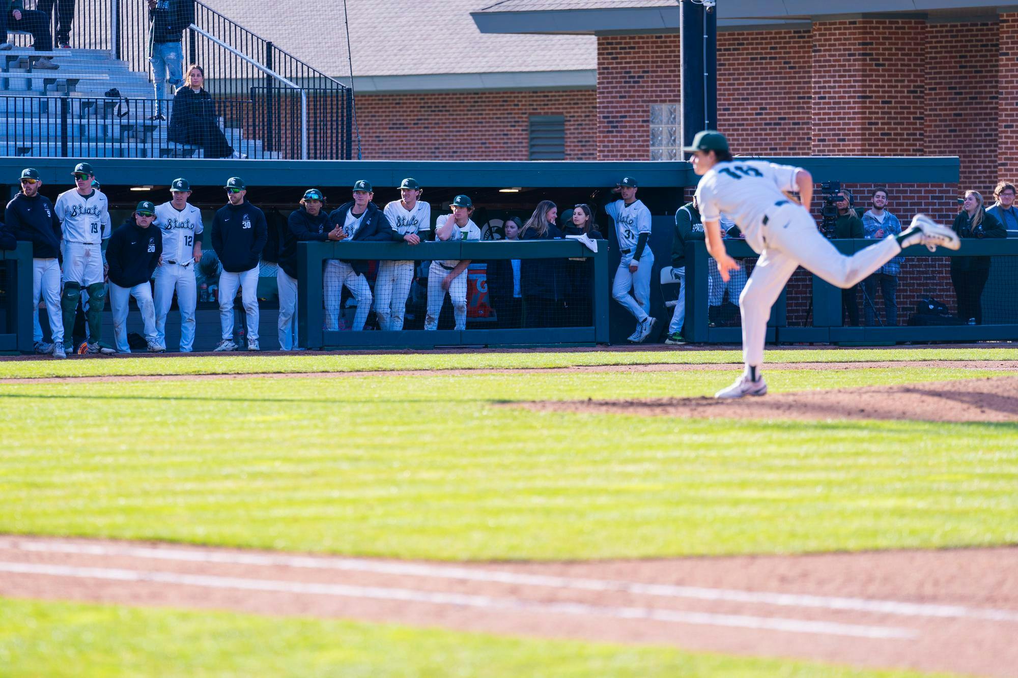 <p>MSU baseball players watch as sophomore pitcher No. 16 Joseph Dzierwa throws a pitch during the team’s home opener vs. the University of Evansville at McLane Baseball Stadium on March 15, 2024.</p>