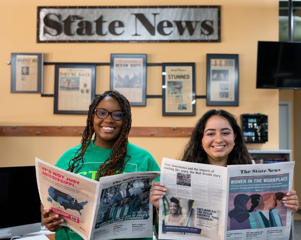 Editor in Chief Sa'Mya Overall (left) and Managing Editor Dina Kaur (right) pose with issues of The State News in which their respective stories were the covers on Aug. 24, 2022.