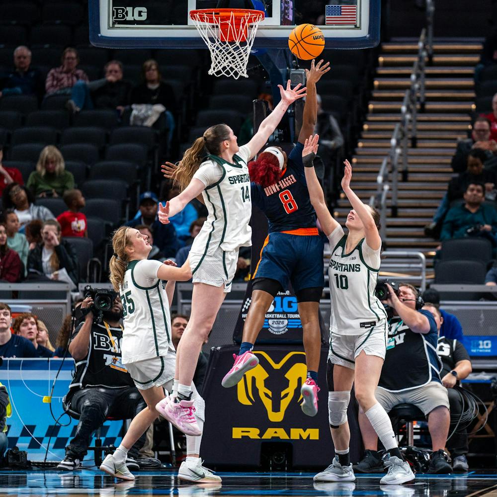 MSU Sr. F, Grace VanSlooten (14), along with her teammates, R-So. G, Kennedy Blair (35) and So. F, Inés Sotelo (10), try to block an Illinois player from scoring in the Gainbridge Fieldhouse in Indianapolis, IN on March 5, 2026.