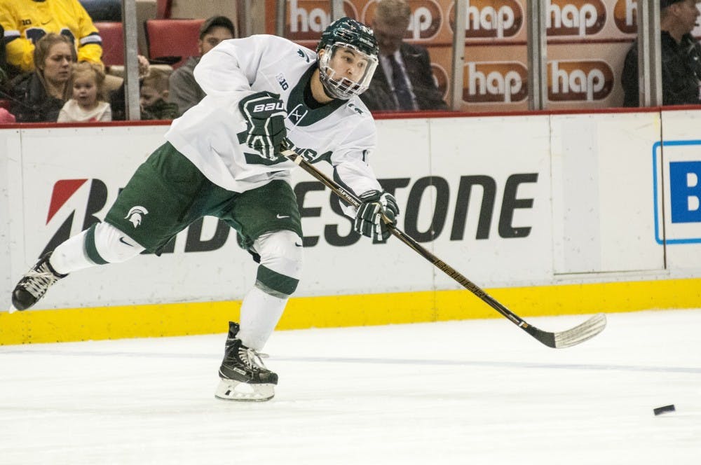 Freshman wingman Taro Hirose (17) passes the puck during the second period of the 52nd Annual Great Lakes Invitational third-place game against the University of Michigan on Dec. 30, 2016 at Joe Louis Arena in Detroit. The Spartans were defeated by the Wolverines in overtime, 5-4.