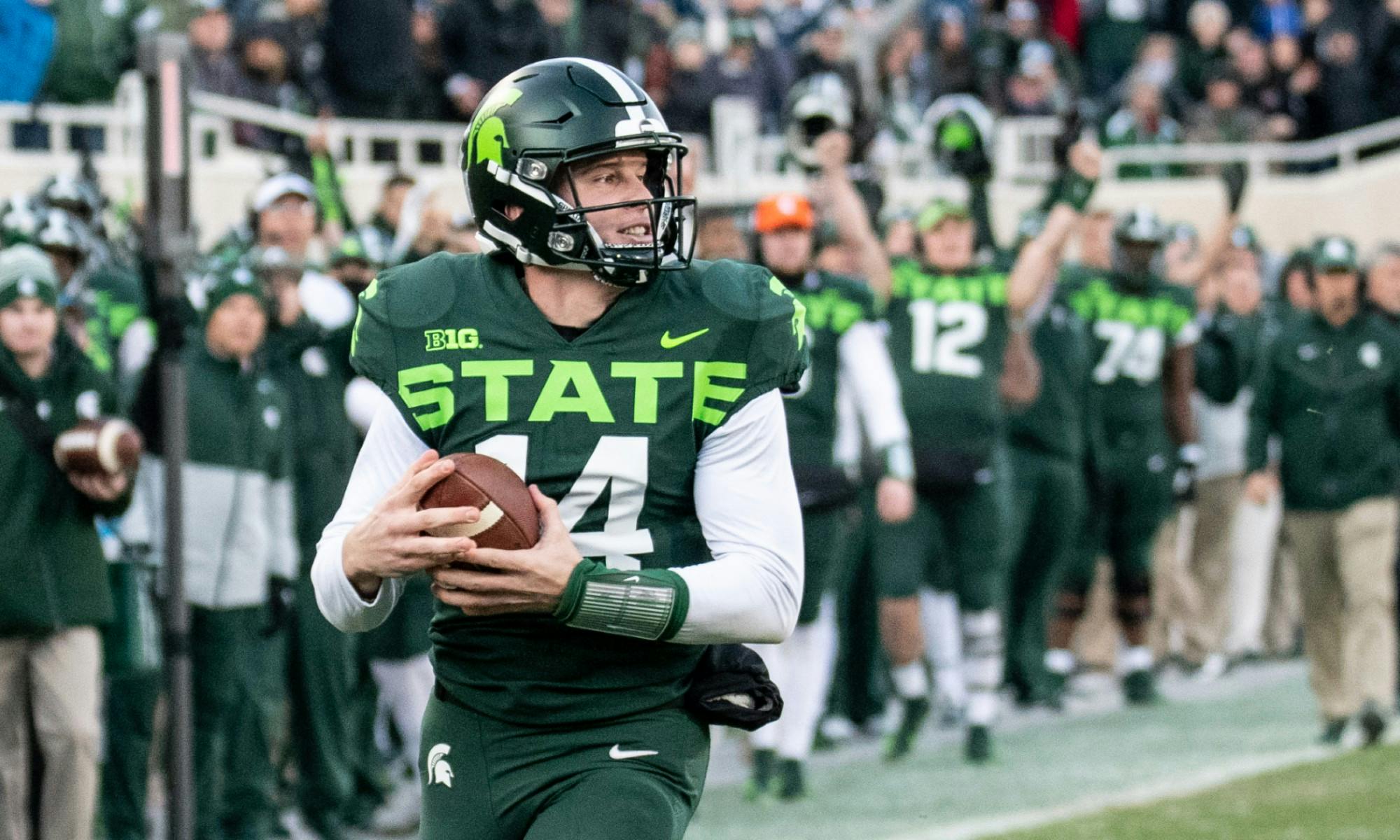 <p>Redshirt senior quarterback Brian Lewerke (14) runs into the end zone during the game against Illinois on Nov. 9, 2019 at Spartan Stadium.</p>