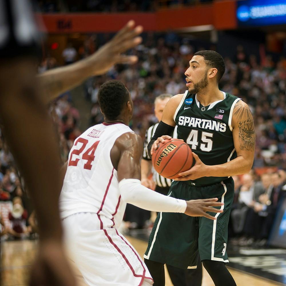 <p>Junior guard Denzel Valentine looks to make a pass March 27, 2015, during the East Regional round of the NCAA Tournament in a game against Oklahoma at the Carrier Dome in Syracuse, New York. The Spartans the Sooners, 62-58. Erin Hampton/The State News</p>