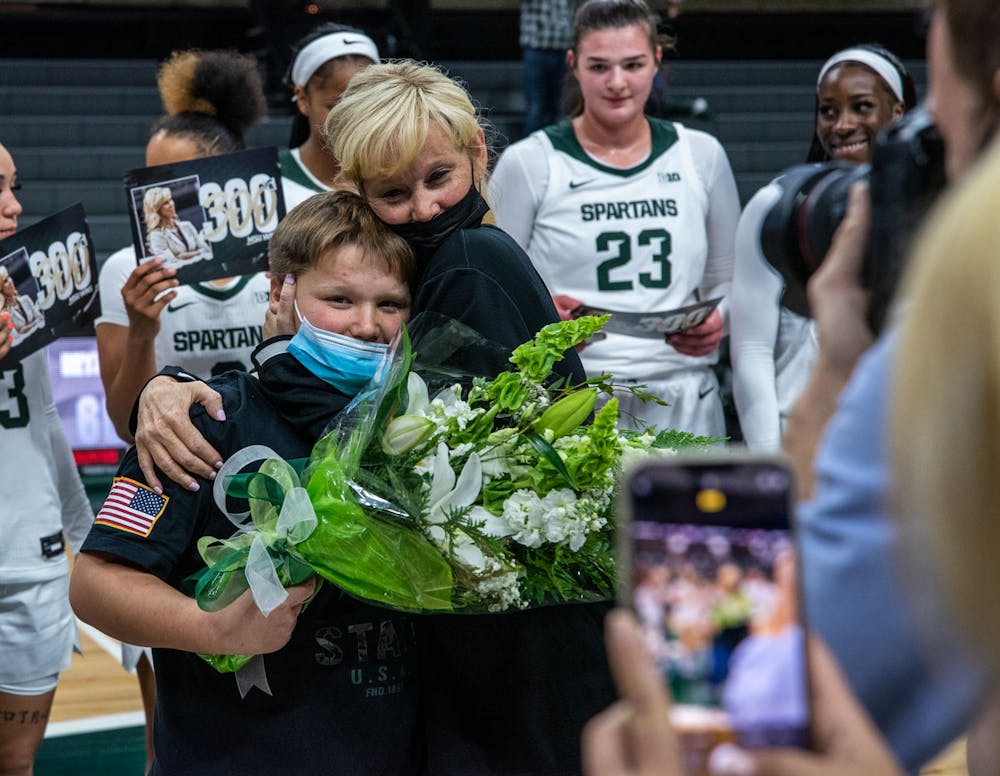 <p>Coach Suzy Merchant hugs her son after her 300th win as head coach at Michigan State. The Spartans crushed the Bryant Bulldogs, 100-60, on Nov. 19, 2021.</p>
