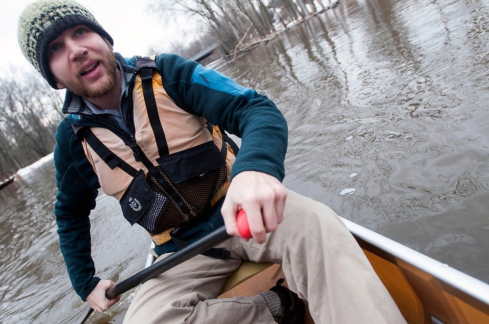 <p>Michigan State alumnus Tom Baweja paddles in a canoe March 20, 2014, on the Red Cedar River near Kruger Landing.  Baweja and his team plan to canoe the entire Mississippi River in less than 18 days this coming May.  Allison Brooks/The State News</p>