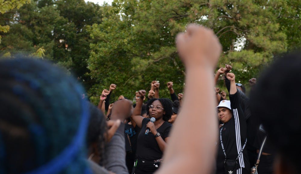 <p>Black Student Alliance MSU president Sharron Reed-Davis gave a speech protesting the newly implemented block tuition at MSU during Spartan Remix behind Wells Hall on Sept. 5, 2019. Many students wore black to the event in support of the protest. </p>