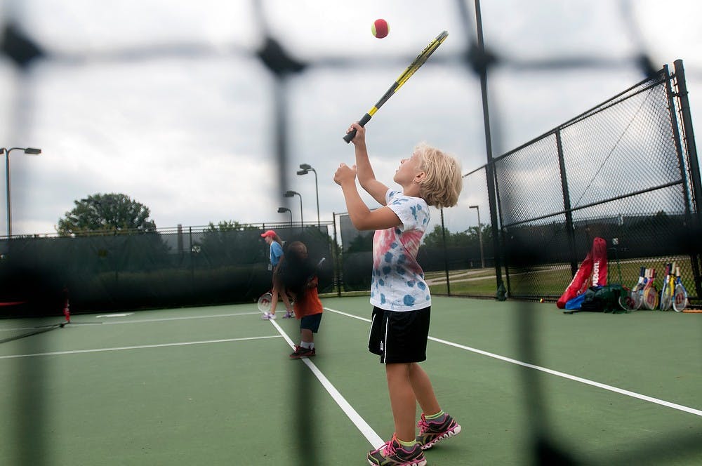 	<p>Tillsonburg, Ontario, resident Charlotte Bolton, 10, serves the ball during a doubles tennis Aug. 6, 2013, during the World Dwarf Games at the tennis courts on Wilson Road. Bolton was just having fun on her day off. Weston Brooks/The State News</p>