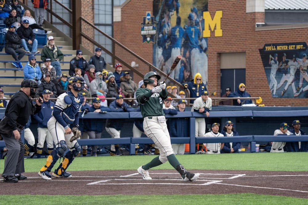 <p>Spartan first baseman Brock Vradenburg watches the ball fly over the fence against Michigan on April 23, 2023.</p>