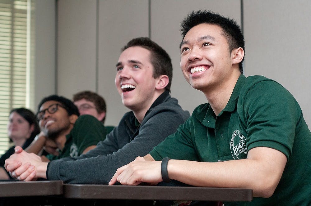 	<p>Finance senior William Adams, left, and advertising senior Vu Nguyen smile during a workshop at the Spartan Leadership Conference Feb. 16, 2013, at Case Hall. The conference was hosted by the Residence Halls Association and emphasized improving life skills. </p>