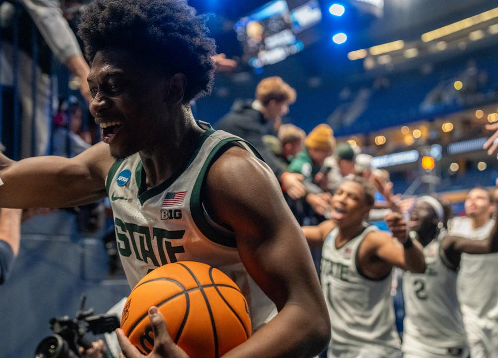 Michigan State men’s basketball players high-five fans after defeating the University of Louisville at the KeyBank Center in Buffalo, New York on March 21, 2026.