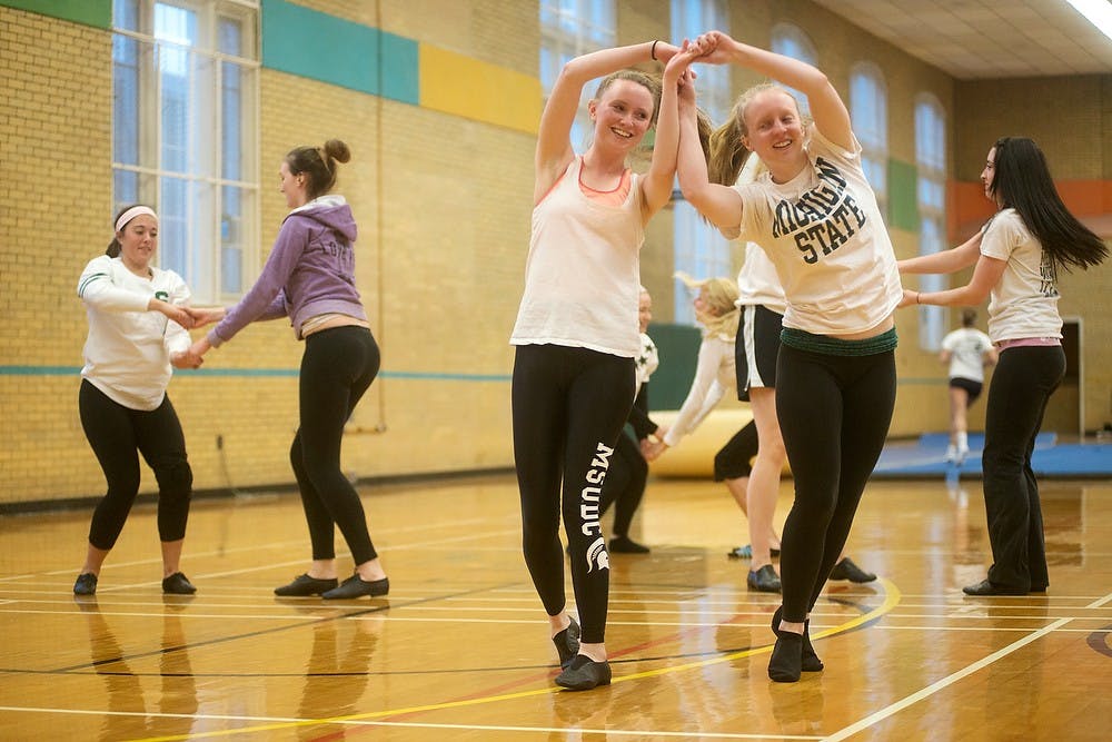 <p>Advertising sophomore Rebecca Fowler, left, and human development and family studies junior Liz Marjamaa dance during a MSU Dance Club practice April 8, 2014, at IM Sports-Circle. The group was practicing for an upcoming recital Sunday. Julia Nagy/The State News</p>