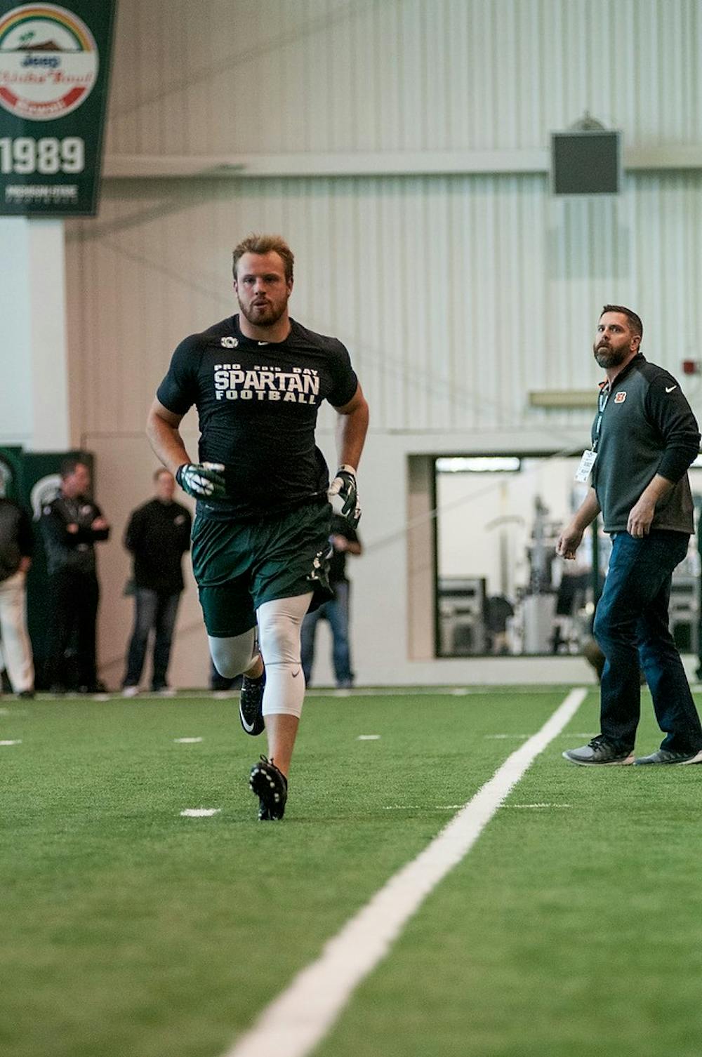 <p>Senior defensive end Marcus Rush finishes a drill Mar. 18, 2015, during Pro Day at the Duffy Daugherty Building. NFL scouts and coaches came to the event to check out Spartan NFL prospects. Kelsey Feldpausch/The State News</p>