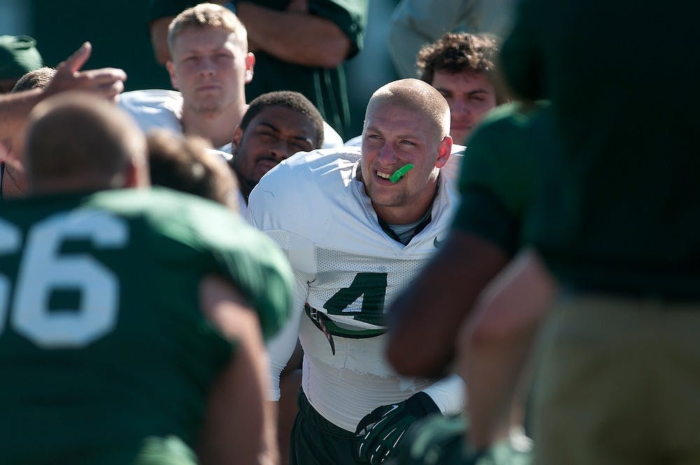 	<p>Senior linebacker Max Bullough listens in a huddle Aug. 9, 2013, at the practice field outside Duffy Daugherty Football Building. Julia Nagy/The State News</p>