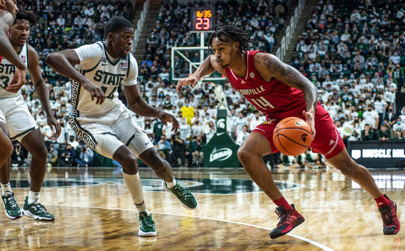 <p>Senior forward Gabe Brown (44) guards Louisville&#x27;s Dre Davis during the second half. The Spartans beat the Cardinals, 73-64, to win the B1G/ACC Challenge on Dec. 1, 2021. </p>