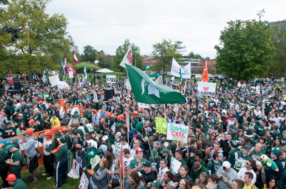 <p>Football fans put their signs and other paraphernalia  on Sept. 12, 2015, at ESPN's College Gameday at Munn field. Hundreds of students arrived early in the morning for a chance to see the live taping. Jack Stephan/ The State News</p>