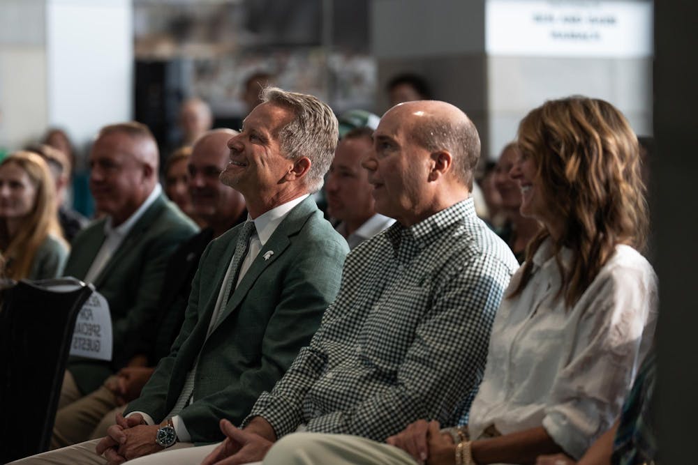<p>President Kevin Guskiewicz listens to Michigan State University's new vice president and athletic director, Dan Bartholomae, speak at a press conference in the Breslin Center in East Lansing, Mich., on Aug. 19, 2026.</p>
