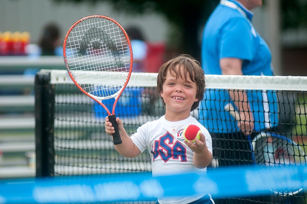 	<p>Indianapolis resident Eric Dessaver, 8,  plays doubles tennis August 6, 2013, during the World Dwarf Games at the tennis courts on Wilson Road. It was Dessaver&#8217;s first time playing tennis. Weston Brooks/The State News</p>