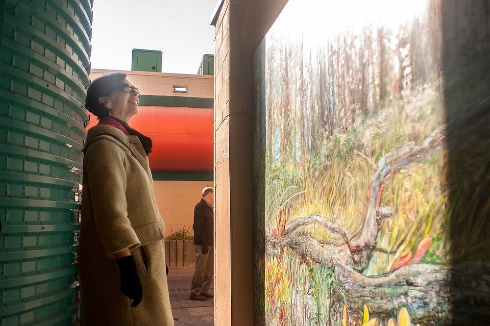 Program manager of the Arts Council of Greater Lansing, Barb Whitney, examines the mural illustrated by artist Tony Hendrick in the Division Street parking ramp on Nov. 8, 2012.  Katie Stiefel/ State News