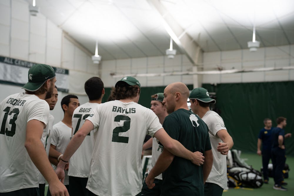 <p>The MSU men's tennis team huddles up before their match against Michigan at the MSU Tennis Center on March 30, 2023. The Spartans lost to the Wolverines 6-1.</p>