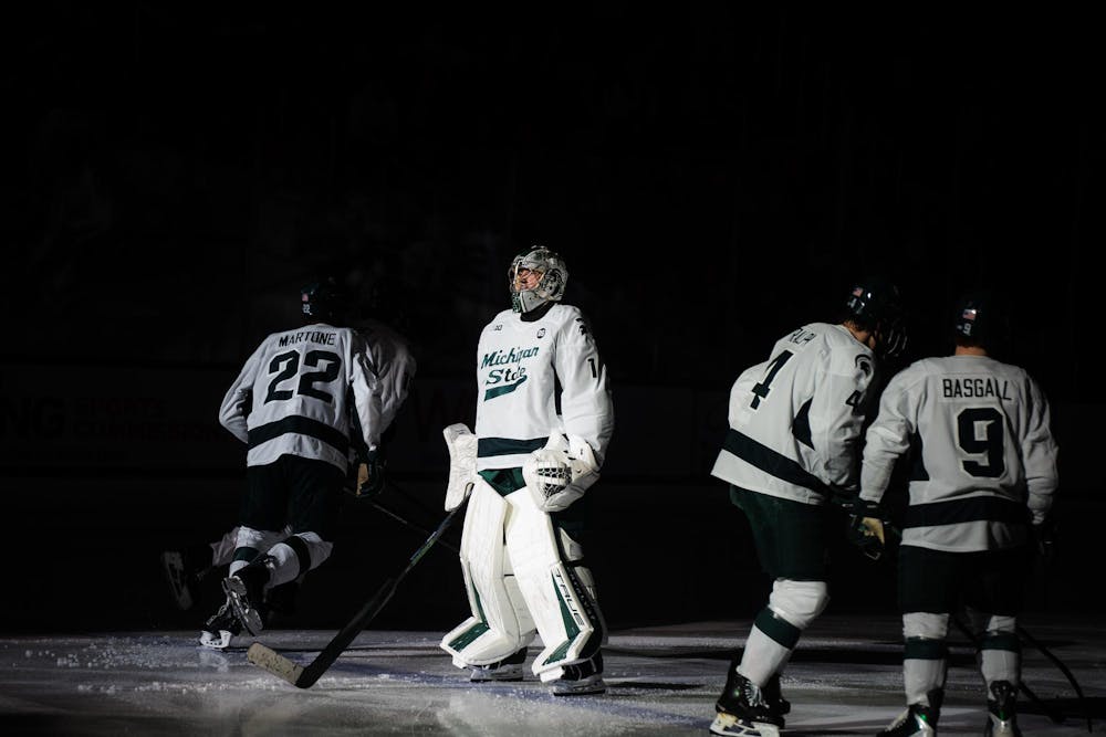 Trey Augustine (1), a junior goalie for Michigan State University, faces University of Notre Dame as teammates skate off following pregame greetings at Munn Ice Arena in East Lansing, Michigan, on Friday, Feb. 20, 2026.