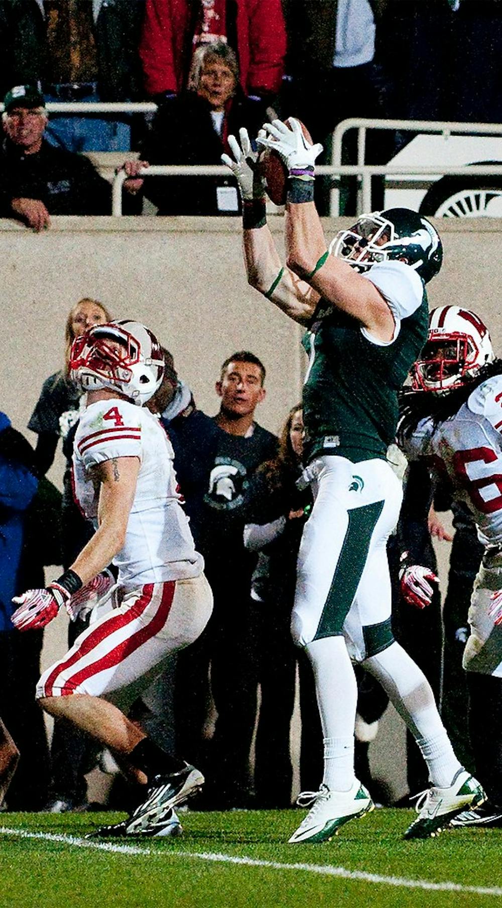 	<p>Senior wide receiver Keith Nichol catches a tipped ball which he took to the endzone for the win over the Badgers. The Spartans defeated Wisconsin, 37-31, on Saturday night at Spartan Stadium. Josh Radtke/The State News</p>